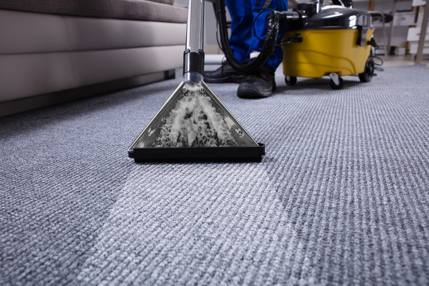 Janitor's Hand Cleaning Carpet With Vacuum Cleaner